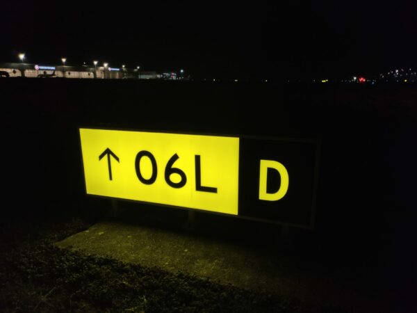 Airport Guidance Sign Yellow Illuminated Night time