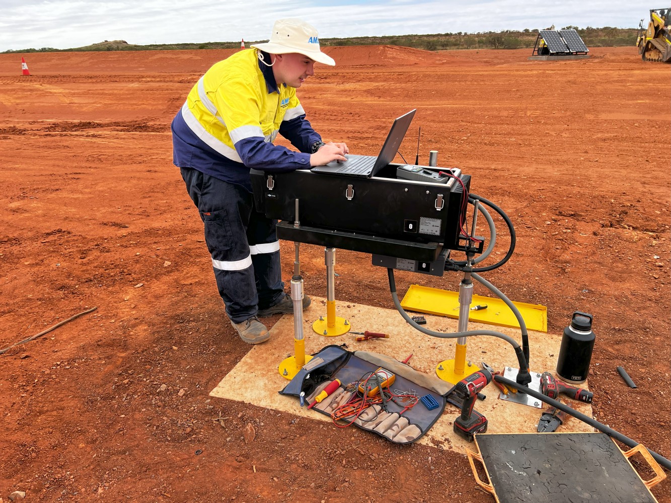 An AGL team worker is installing S4GA Solar Airfield Lighting in high-heat conditions